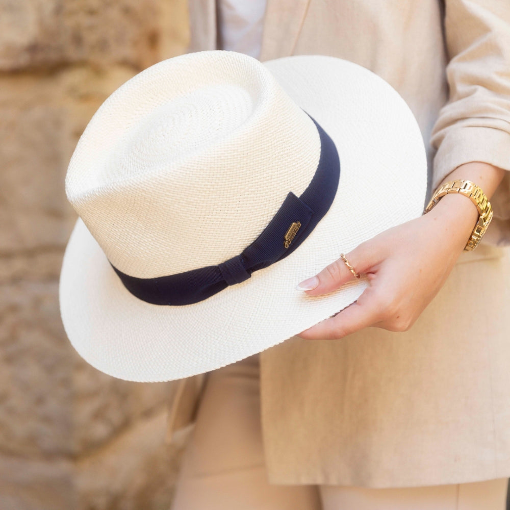 Female Model holding a genuine Panama hat behind in her hands