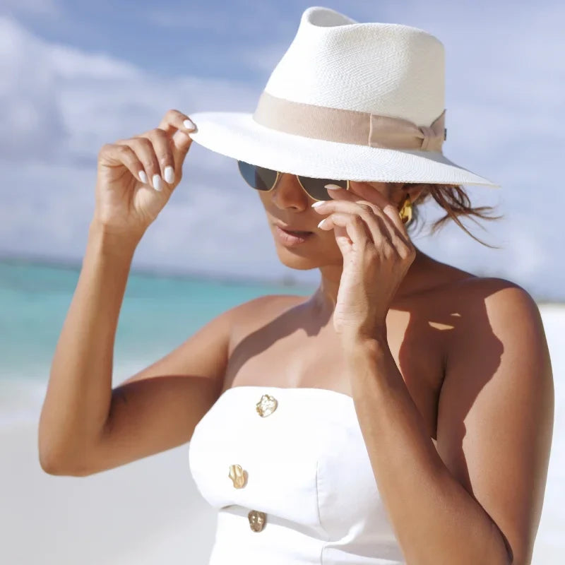 Female Model holding a genuine Panama hat behind in her hands